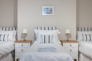 Bedroom with four single beds in the Central Brighton Town House